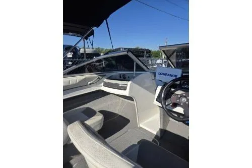 Slide: The Image of 2013 Bayliner 185 Bowrider interior with steering wheel and seating, featuring Lowrance equipment. - 7