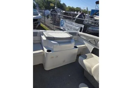 Slide: The Image of 2013 Bayliner 185 Bowrider interior with seating and storage, parked outdoors. - 8