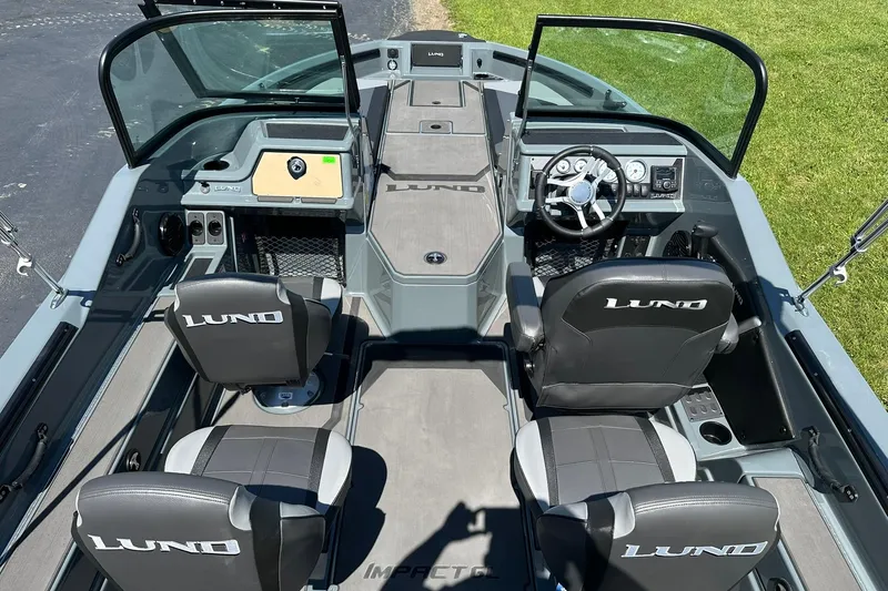 Slide: The Image of 2026 Lund 185 Impact GL boat interior with steering wheel and seating. - 11