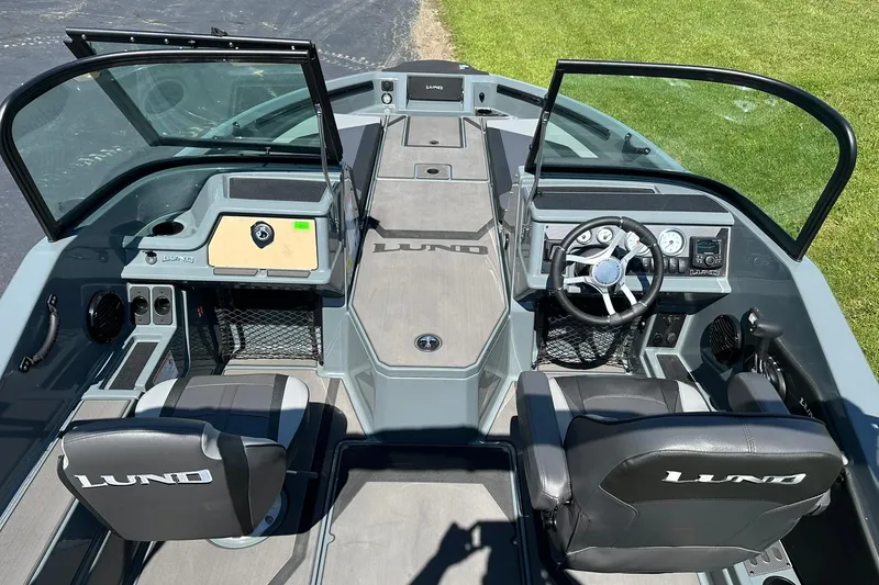 Slide: The Image of 2026 Lund 185 Impact GL boat interior with dual consoles and steering wheel. - 12