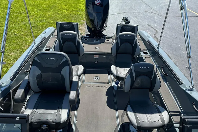 Slide: The Image of 2026 Lund 185 Impact GL boat interior with four cushioned seats and sleek design. - 13