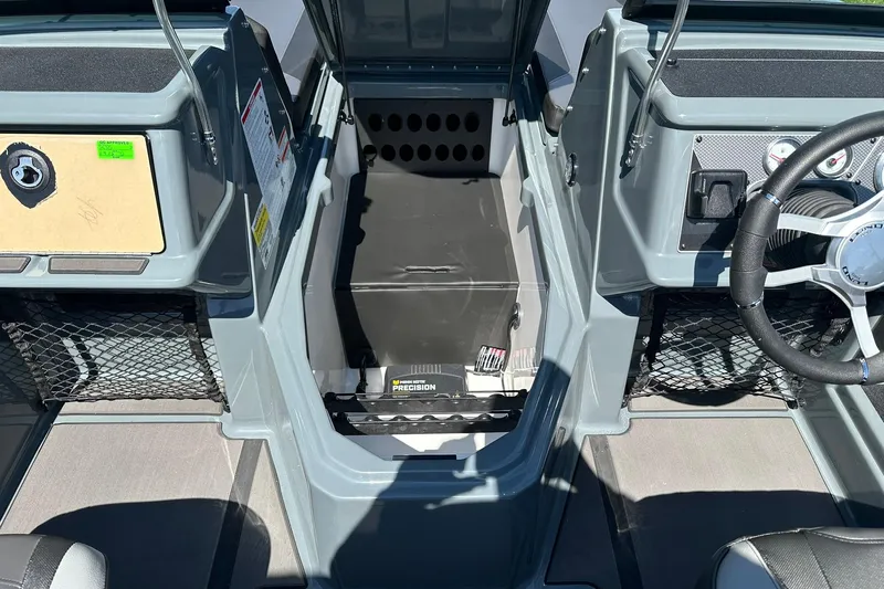 Slide: The Image of 2026 Lund 185 Impact GL boat interior with steering wheel and storage compartments. - 22