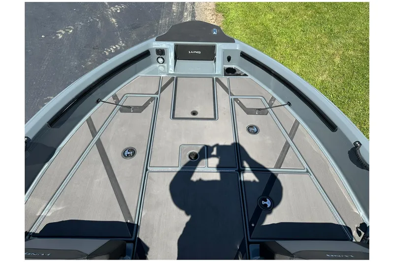 Slide: The Image of 2026 Lund 185 Impact GL boat deck with storage compartments and shadow. - 29