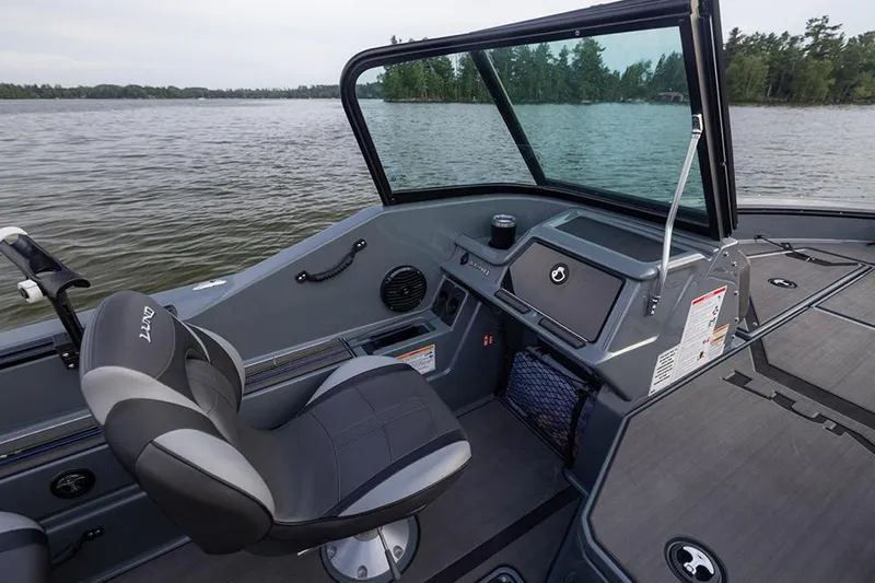 Slide: The Image of Manufacturer Provided Image: 2025 Lund 185 Impact GL boat interior with seating and dashboard on a lake. - 49