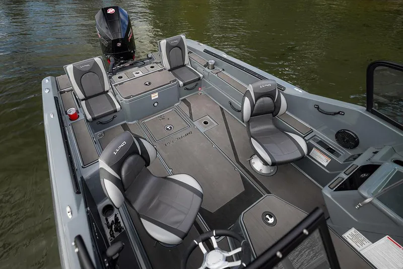 Slide: The Image of Manufacturer Provided Image: 2025 Lund 185 Impact GL boat interior with seating and steering, on calm water. - 50