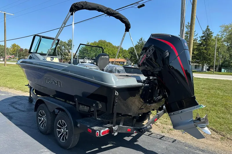 Slide: The Image of 2026 Lund 185 Impact GL boat with powerful outboard motor on trailer. - 8