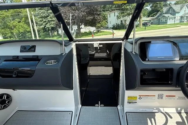 Slide: The Image of Interior view of 2026 Regal LS4 boat, featuring modern dashboard and seating area. - 10