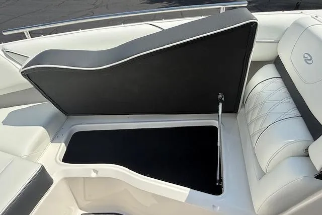 Slide: The Image of 2026 Regal LS4 boat interior with open storage compartment and white cushioned seating. - 13
