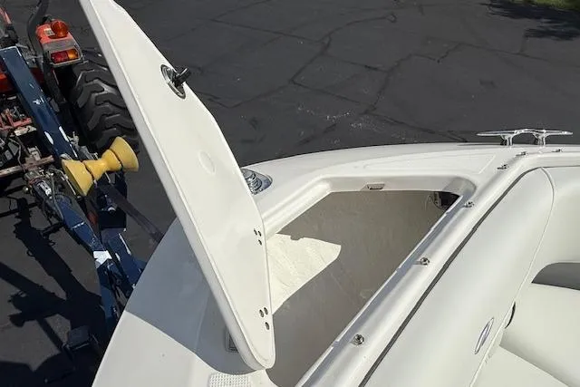 Slide: The Image of 2026 Regal LS4 boat with open storage compartment, parked on a trailer. - 16