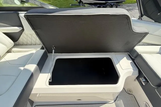 Slide: The Image of 2026 Regal LS4 boat with open storage compartment, showcasing spacious interior design. - 19