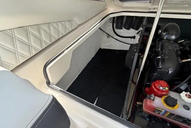 Slide: The Image of Engine compartment of 2026 Regal LS4 boat, featuring quilted interior and visible engine components. - 27