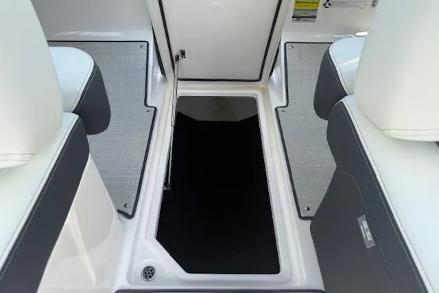 Slide: The Image of 2026 Regal LS4 boat interior with open storage compartment and cushioned seating. - 28