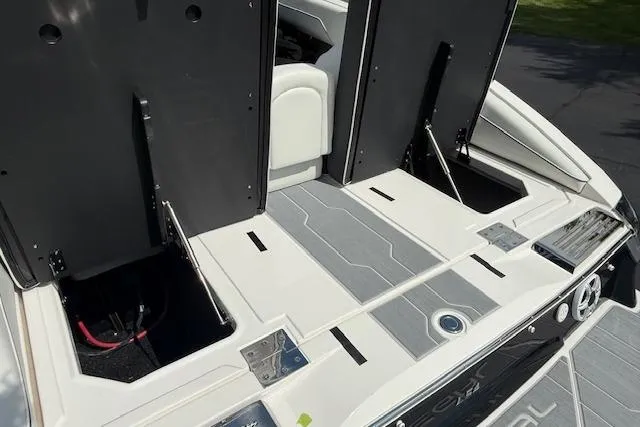Slide: The Image of 2026 Regal LS4 boat deck with open storage compartments and sleek design. - 29