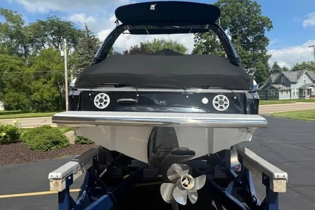 Slide: The Image of 2026 Regal LS4 boat on trailer, rear view with covered deck and visible propeller. - 32