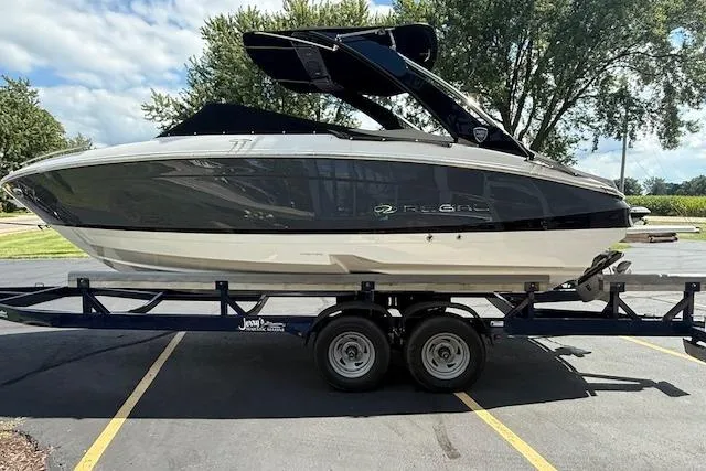 Slide: The Image of 2026 Regal LS4 boat on trailer, parked outdoors under clear sky. - 33