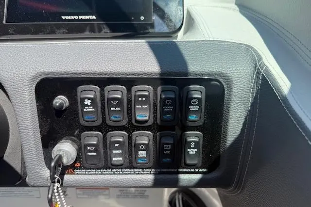 Slide: The Image of Control panel of a 2026 Regal LS4 boat with various switches and buttons. - 6
