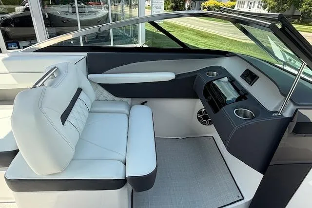 Slide: The Image of 2026 Regal LS4 boat interior with white seating, modern dashboard, and cup holders. - 8