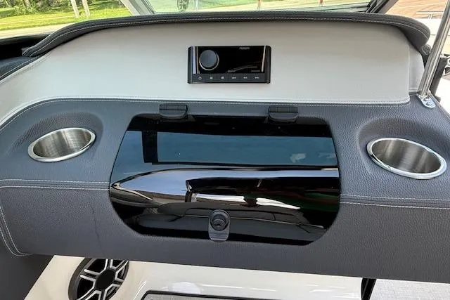 Slide: The Image of Dashboard of 2026 Regal LS4 boat with cup holders and audio system. - 9