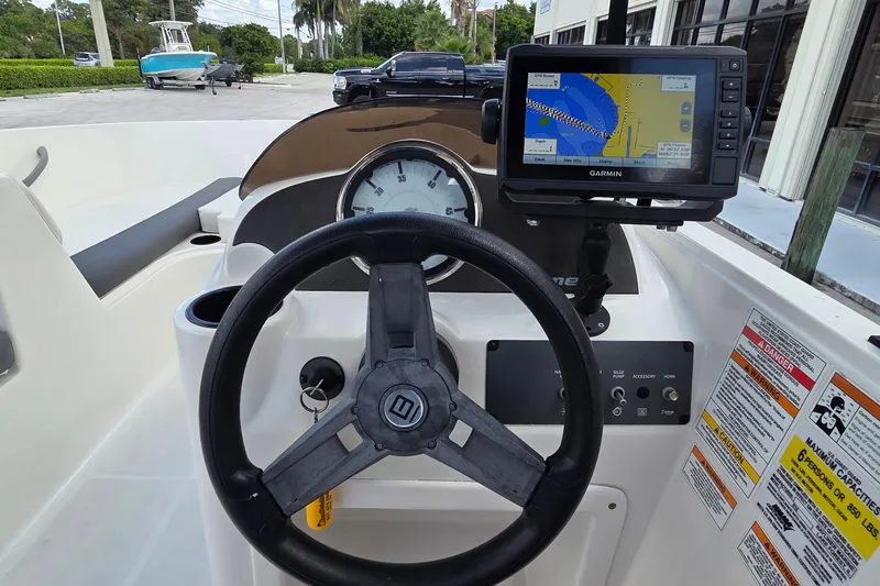 Slide: The Image of 2020 Bayliner Element E16 dashboard with steering wheel and Garmin GPS display. - 4