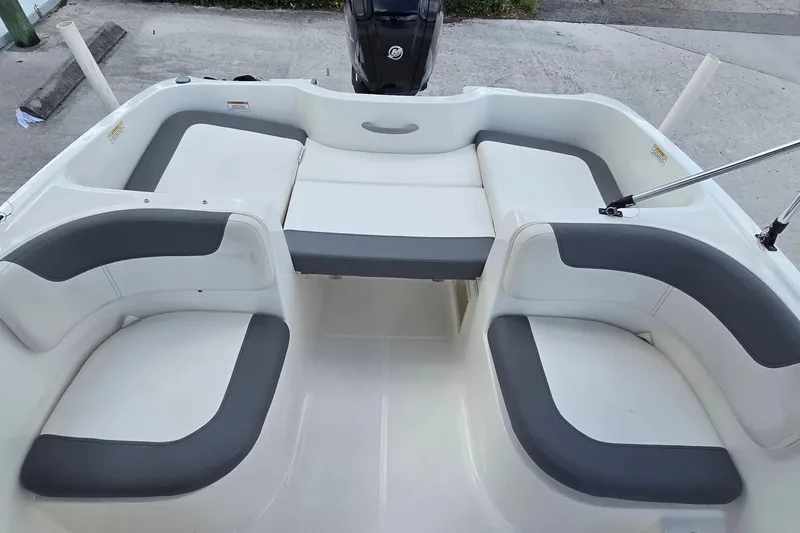 Slide: The Image of 2020 Bayliner Element E16 boat interior with gray and white seating arrangement. - 6