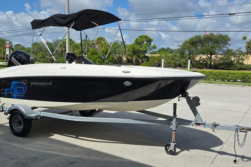 Slide: The Image of 2020 Bayliner Element E16 boat on trailer with canopy, parked outdoors. - 9