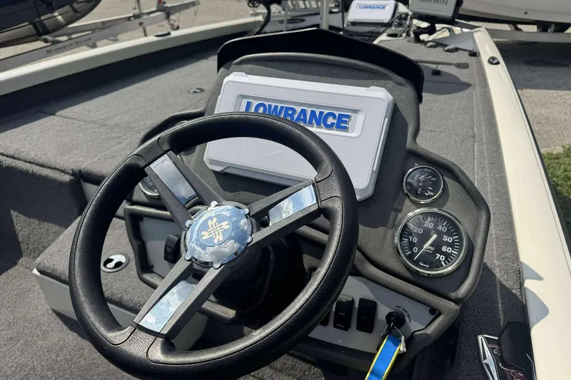 Slide: The Image of 2021 Ranger RT188P boat dashboard with steering wheel, Lowrance display, and gauges. - 4