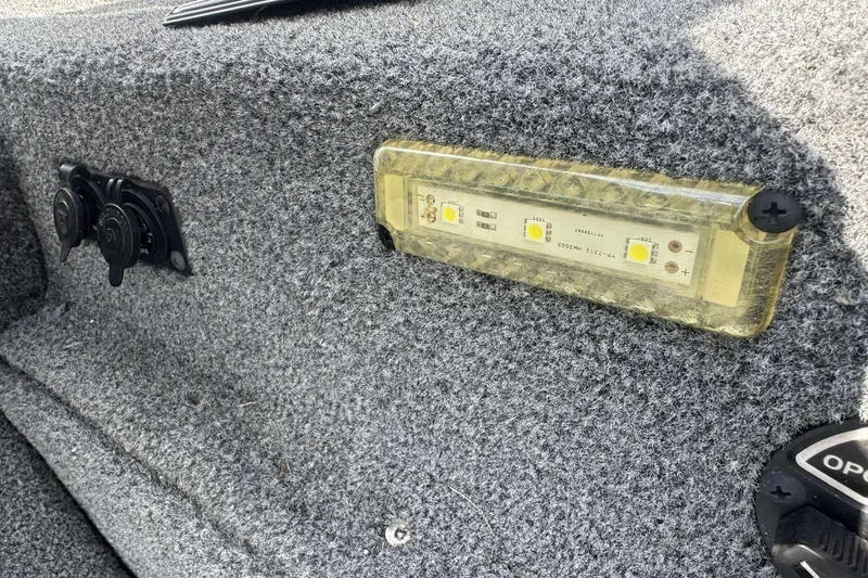 Slide: The Image of 2021 Ranger RT188P boat interior with LED light and power outlets on carpeted surface. - 7