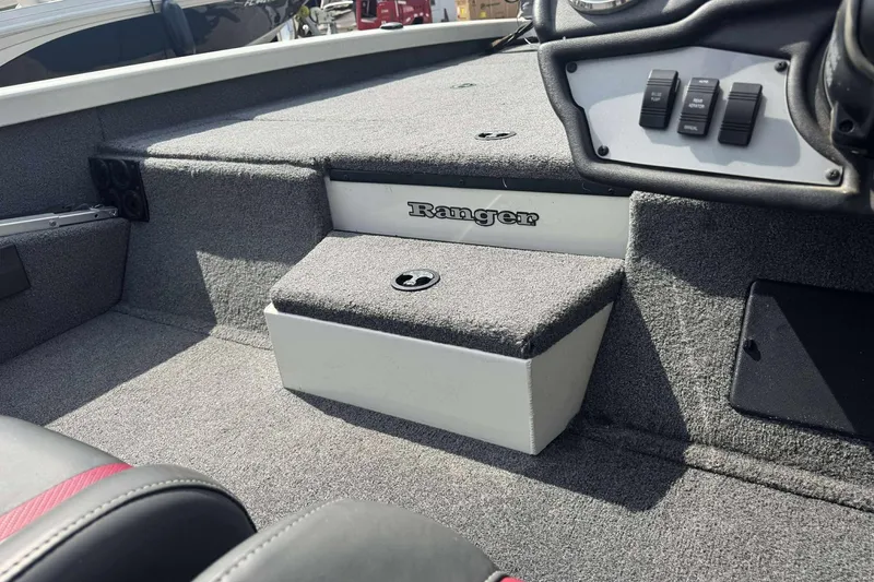 Slide: The Image of 2021 Ranger RT188P boat interior with carpeted steps and control panel. - 8