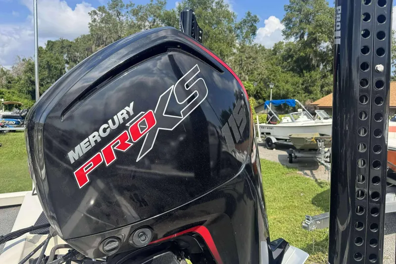 Slide: The Image of Mercury Pro XS engine on 2021 Ranger RT188P boat, outdoors with trees and boats in background. - 9