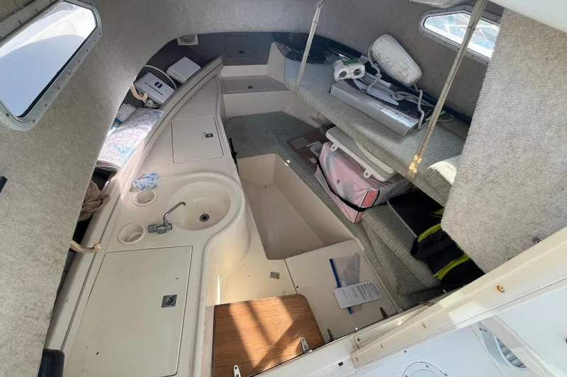 Slide: The Image of 1999 Grady-White Gulfstream 232 cabin interior with sink and seating area. - 10