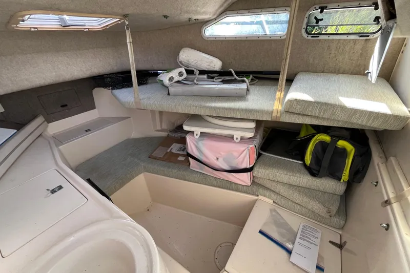 Slide: The Image of 1999 Grady-White Gulfstream 232 cabin interior with storage and seating. - 11