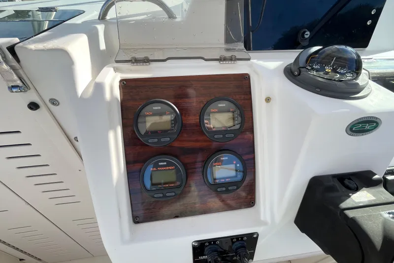 Slide: The Image of 1999 Grady-White Gulfstream 232 dashboard with Yamaha gauges and compass. - 13