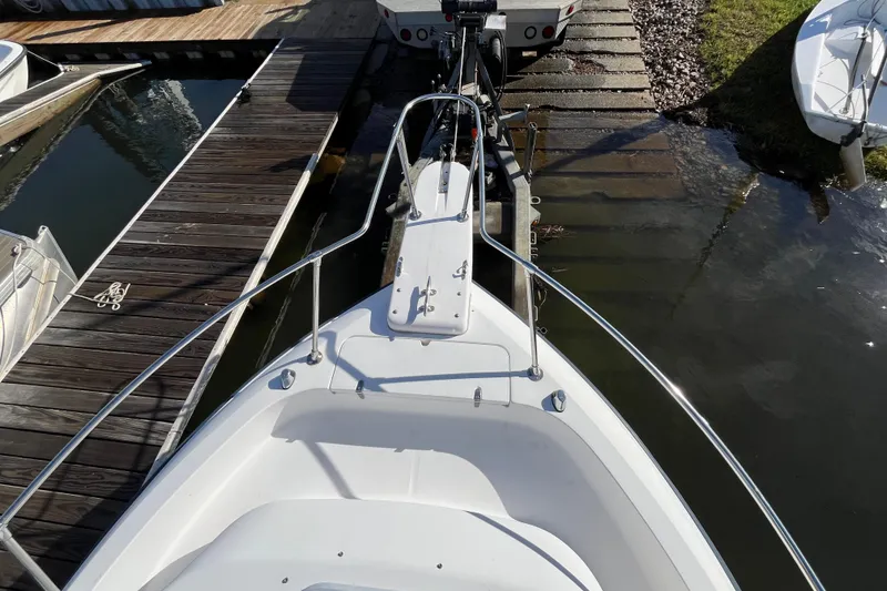 Slide: The Image of 1999 Grady-White Gulfstream 232 boat docked at a marina ramp. - 21