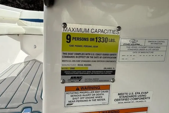 Slide: The Image of Regal 2000 Bowrider 2012 capacity label, max 9 persons or 1330 lbs, safety warnings. - 10