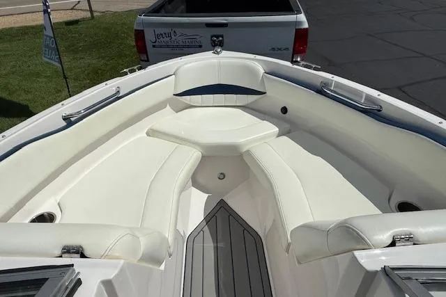 Slide: The Image of 2012 Regal 2000 Bowrider boat interior with white seating and sleek design. - 12