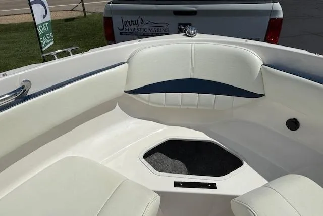 Slide: The Image of 2012 Regal 2000 Bowrider boat interior with white seating and storage compartment. - 13