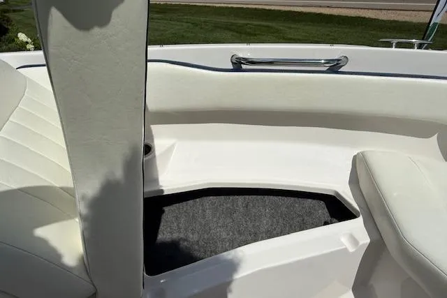 Slide: The Image of Interior of a 2012 Regal 2000 Bowrider boat with white seating and carpeted floor. - 14