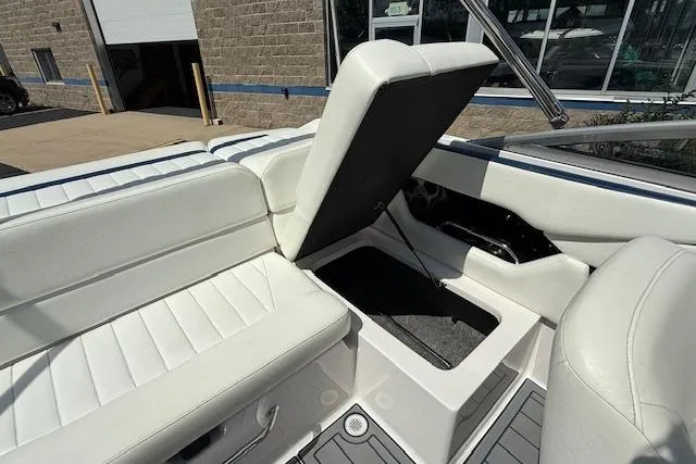 Slide: The Image of 2012 Regal 2000 Bowrider interior with white seating and storage compartment. - 17