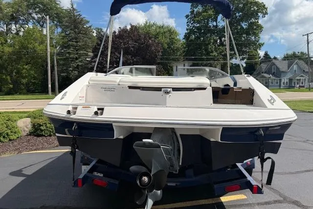 Slide: The Image of 2012 Regal 2000 Bowrider boat on trailer, parked outdoors, rear view. - 2