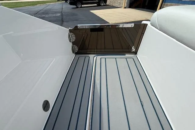 Slide: The Image of 2012 Regal 2000 Bowrider boat interior with sleek, modern design and striped flooring. - 26
