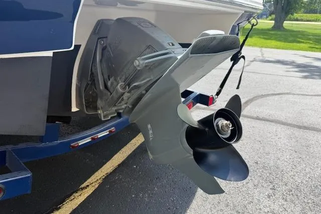 Slide: The Image of 2012 Regal 2000 Bowrider boat propeller and stern, parked on pavement. - 28