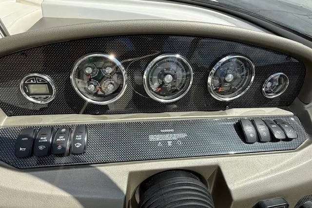 Slide: The Image of Dashboard of 2012 Regal 2000 Bowrider boat with gauges and control switches. - 9
