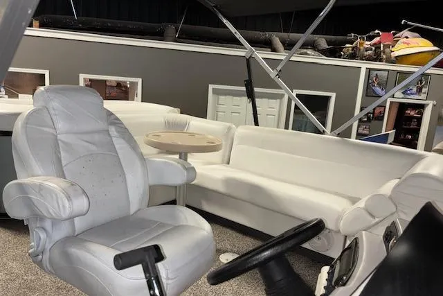 Slide: The Image of Interior of 2002 Aqua Patio AP 220 R pontoon boat with white seating and steering console. - 10