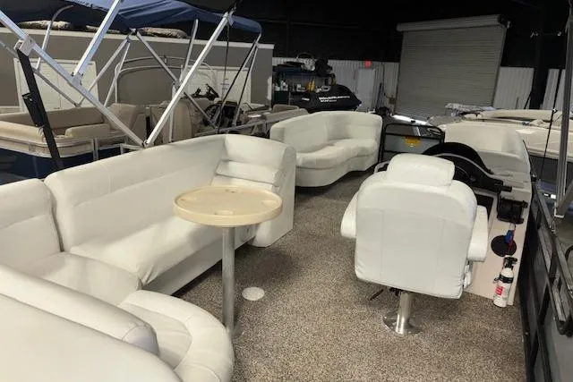 Slide: The Image of Interior of 2002 Aqua Patio AP 220 R pontoon boat with white seating and table. - 11