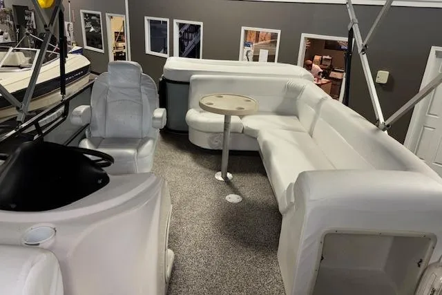 Slide: The Image of 2002 Aqua Patio AP 220 R pontoon boat interior with white seating and table. - 13