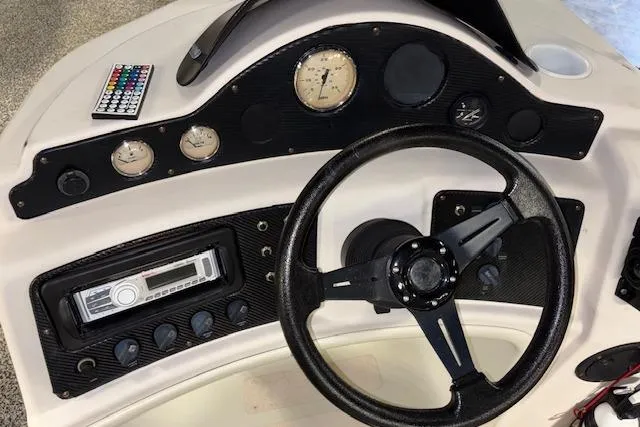 Slide: The Image of Steering console of 2002 Aqua Patio AP 220 R with gauges and controls. - 15