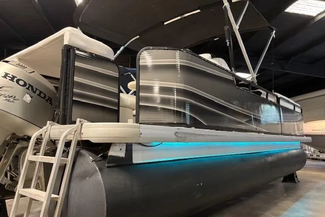 Slide: The Image of 2002 Aqua Patio AP 220 R pontoon boat with Honda engine in indoor storage. - 17