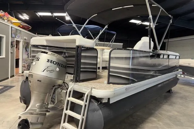Slide: The Image of 2002 Aqua Patio AP 220 R pontoon boat with Honda outboard motor in a showroom. - 4