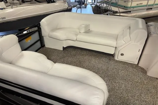 Slide: The Image of 2002 Aqua Patio AP 220 R boat interior with white seating and carpeted floor. - 8