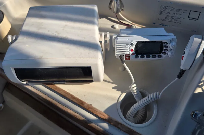 Slide: The Image of 1987 Silverton 34C boat dashboard with marine radio and equipment. - 11
